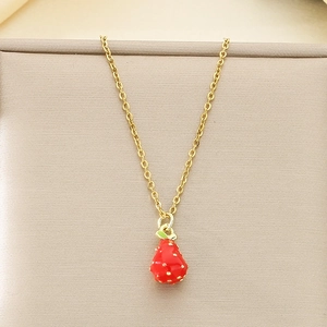 Detailed view of sweet red enamel strawberry pendant on gold-tone stainless steel chain