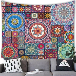 Detail of bohemian mandala tapestry hanging above a gray sofa in a modern living room