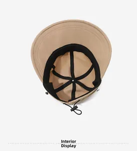 Detail view of khaki bucket hat interior with black lining and adjustable windproof cord