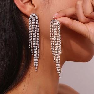 Detail of dangling silver tassel earrings with micro-set zircons shown on model