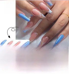 Detailed view of long ballerina nails with blue and pink ombre, glitter, and rhinestones