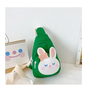 Detail of green canvas bunny crossbody bag for kids with white strap and cute bow