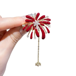 Luxurious red enamel fireworks brooch with dangling gold star chain and sparkling rhinestones