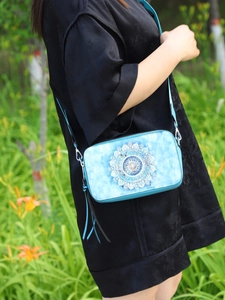 Blue rectangular crossbody bag featuring floral mandala print and stylish tassels
