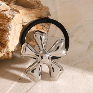 Polished silver fluid flower hair tie with black elastic band on natural stone