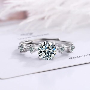Elegant silver open ring with five sparkling zircons on a white minimalist background