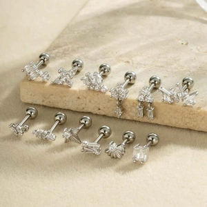 Set of 12 geometric zircon cartilage earrings with screw back on a beige stone base
