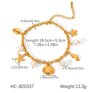 Detail of gold stainless steel shell bracelet with pearls and starfish charms