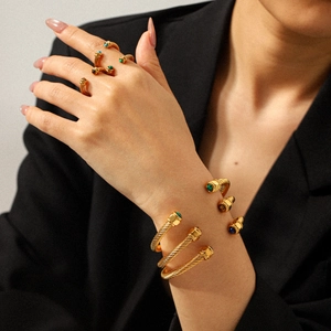 Gold-plated stainless steel cable cuff bracelet with colorful natural stones on a model