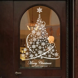 White Christmas tree window sticker with snowflakes and stars on a brown wooden door