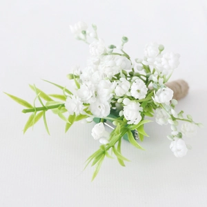 Artificial white baby's breath boutonniere with green leaves and twine wrapped stem