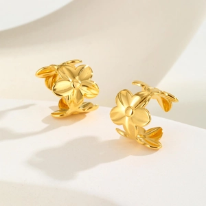 Minimalist gold floral ear cuffs featuring a polished three-flower design for women