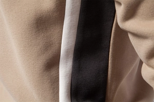 Close-up of khaki white and black stitching on premium knit long sleeve sweatshirt