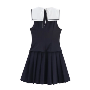Navy blue sleeveless pleated dress with white sailor collar and stripes shown in a flat lay