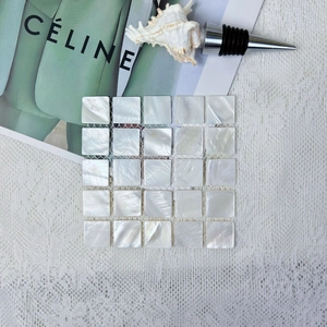 Natural mother of pearl shell mosaic square coaster on elegant white lace background