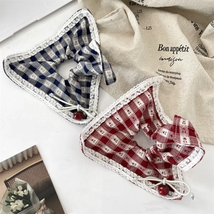Set of navy and red plaid scrunchies with white lace trim and cherry charm accents