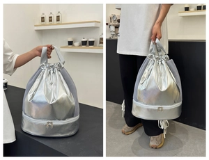 Detail of silver drawstring gym bag with mesh sides and bottom wet-dry compartment