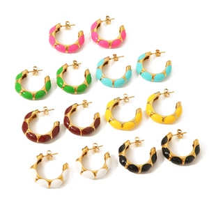 Detail view of 7 colorful enamel C-shape hoop earrings with shiny gold plated finish