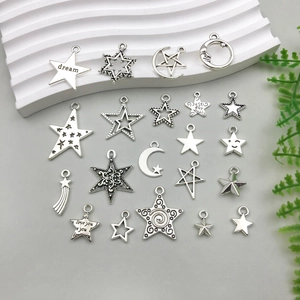 Detail view of silver hollow star and moon pendants for DIY jewelry making