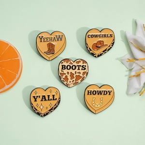 5-pack heart enamel cowboy pins with hat, boot, and horseshoe patterns on green background