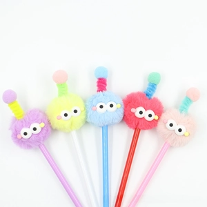 Macro shot of 5 colorful fuzzy monster pens with funny antennas and large cartoon eyes