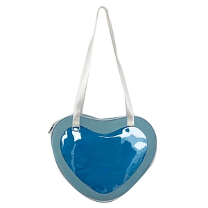 Detailed view of heart-shaped blue PU leather bag with clear PVC window and silver strap