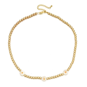 French vintage gold beaded necklace featuring three delicate shell daisy pendants with extension chain