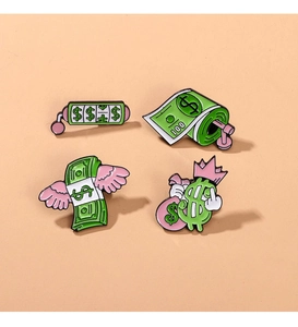 Detail of four creative dollar-themed enamel pins featuring green and pink money motifs