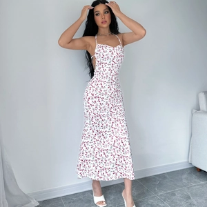 Detail of white floral halter dress showing open back design and slim fit silhouette
