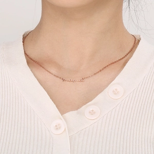 Close-up of Mama pendant necklace in rose gold worn by model for Mother's Day gift