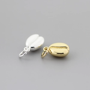Macro shot of gold and silver coffee bean pendants for DIY jewelry making
