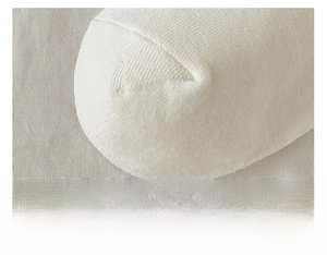 Close-up of flat-seamed toe detail on white cotton socks with fine knit texture