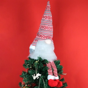 Christmas gnome tree topper with long white beard and red knitted hat on red background
