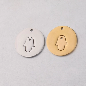 Detailed view of silver and gold Hamsa hand hollowed-out stainless steel pendants