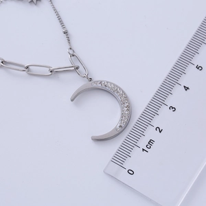 Silver crescent moon necklace size scale showing the 2cm pendant with sparkling crystals