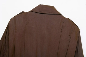 Detail of dark brown jacket showing back collar stitching and shoulder epaulette texture