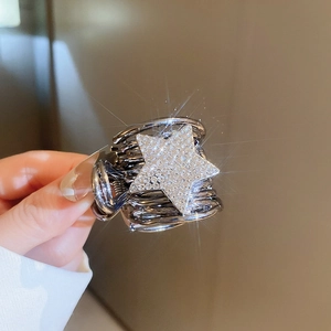 Close-up of sparkling star hair claw clip with rhinestones and metal spiral design