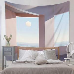 Detail view of a minimalist ocean and moon tapestry hung in a modern cozy bedroom