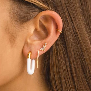 Detailed view of S925 silver gold butterfly stud and tassel spike earring on model ear
