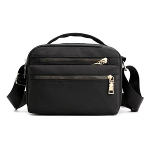 Waterproof black nylon crossbody bag for women with multiple zippered pockets and gold hardware