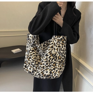 Detail of leopard print tote bag with quilted texture and soft fabric handles