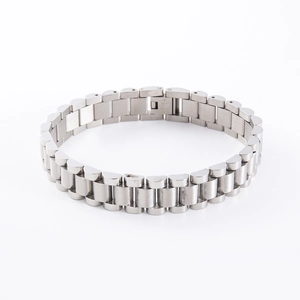 Macro view of silver stainless steel link bracelet featuring polished three-row design