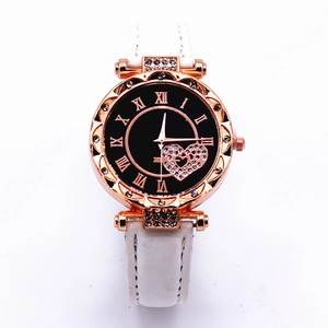 Detail of rose gold watch bezel with rhinestones and heart-shaped dial pattern