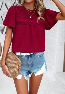 Detail of solid color dark red short sleeve top with lace trim and textured fabric