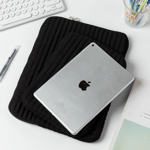 Vertical quilted black laptop sleeve in two sizes with secure top metal zipper closure
