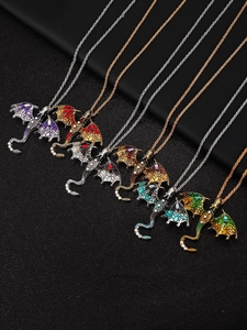 Macro detail of six colorful dragon pendants with crystal diamonds on black leather