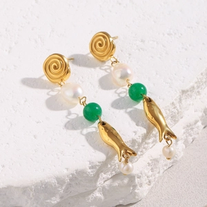 Macro view of 18K gold plated fish tassel earrings with baroque pearls and green jade beads