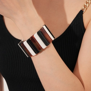 Detail of geometric stretch bracelet featuring black, white and tortoiseshell resin blocks