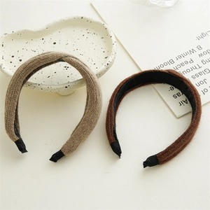 Detail view of knitted milk tea brown and dark brown hairbands with cozy wool texture