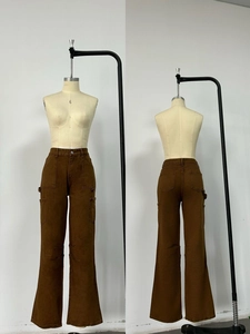 Detail view of high-waist brown cargo jeans with multiple pockets and wide-leg design